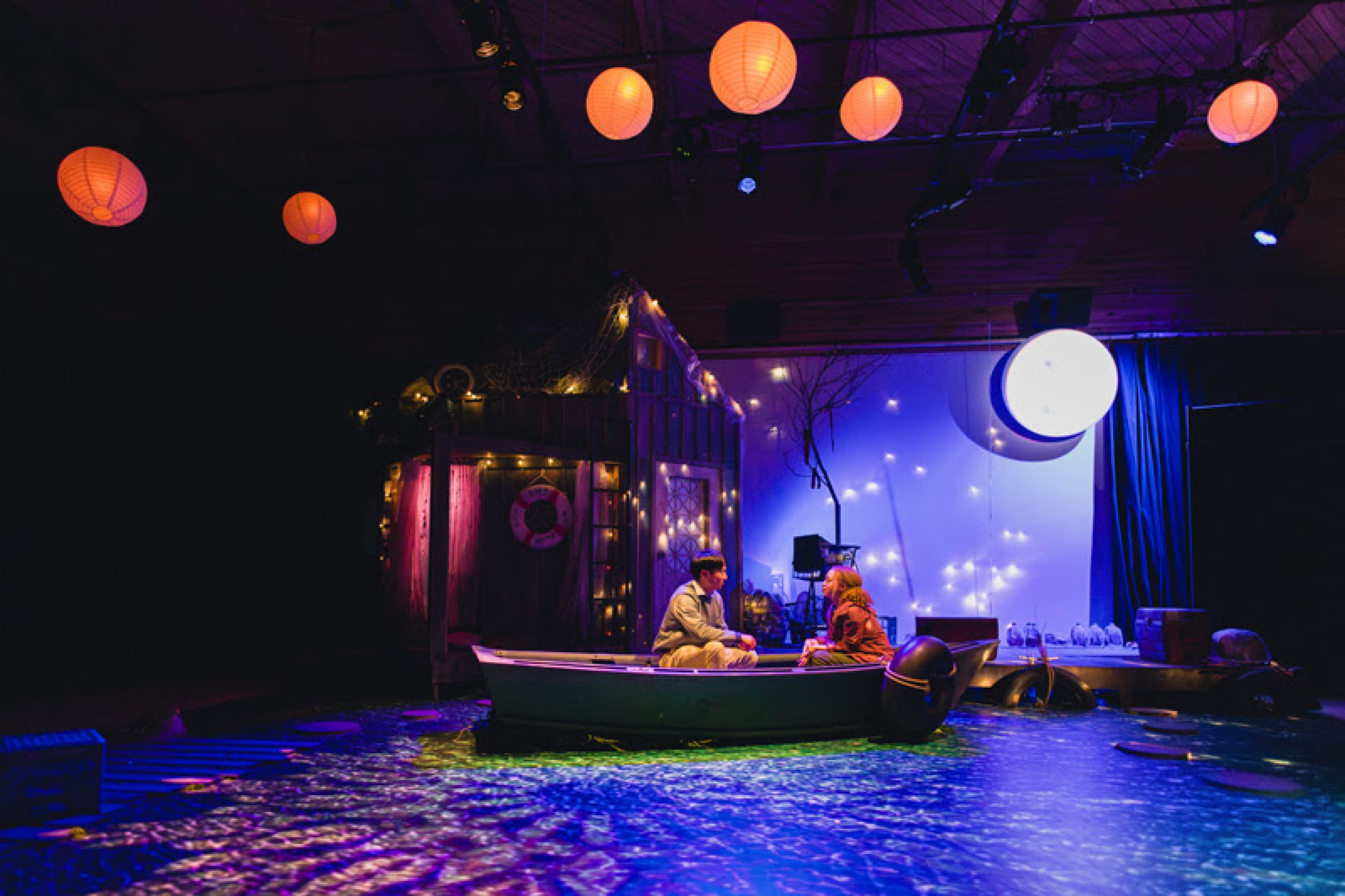 Amy Stewart's illustration of Sara, sitting in a yellow cardigan with her legs crossed, holding a script.